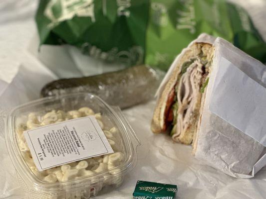 Smoke turkey sandwich Macaroni salad Pickle Jalapeño chips Andre's chocolate