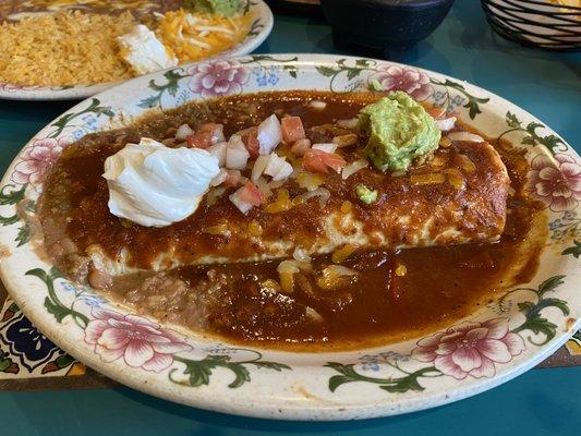 Ground beef burrito with roasted tomato sauce.
