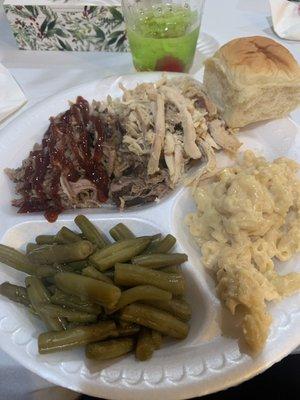 Pulled pork with red sauce, pulled chicken, macaroni and cheese, green beans, and a roll.