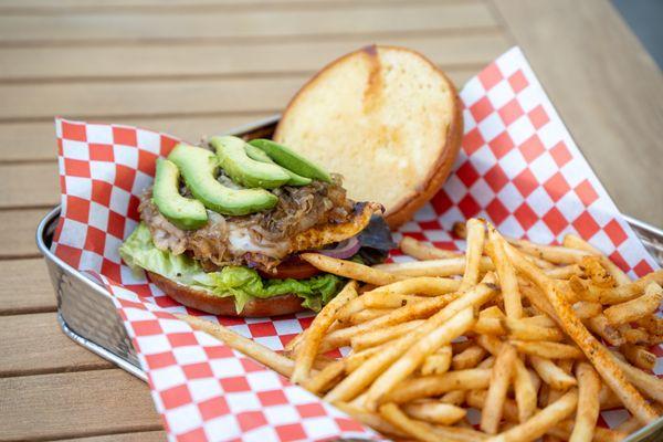 Our grilled chicken sandwich with lettuce, tomato, caramelized shallots, avocado, swiss cheese, and garlic aioli on a brioche bun.