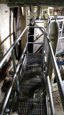 Custom installed 304 S/S catwalk with hand railing and toe kick.