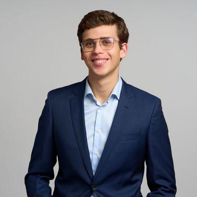 Headshot/portrait against gray.