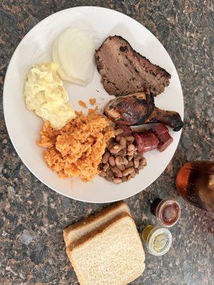 Brisket, Chicken leg, beans, rice, potato salad, sausage.