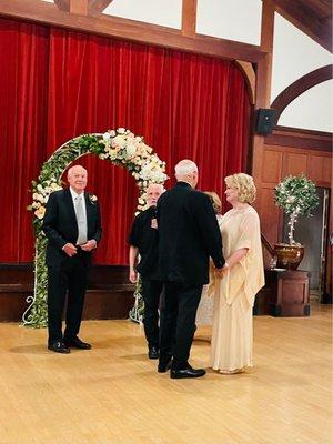 Best man, priest, groom and bride