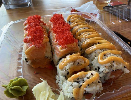 Two rolls: yummy yummy (with masago on top) and a spicy tuna.