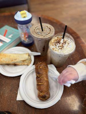 Breakfast burrito, pretzel wrapped sausage, tiramisu cold brew with whip cream, brown cow iced latte and a very happy toddler