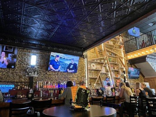 Bar and a glimpse of second level. Cool limestone brick wall.