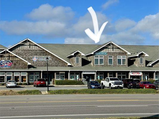 Outside / Exterior pic of shop (where arrow is pointing) taken from other side of highway. Bookstore is on west (sound) side of Croatan Hwy.