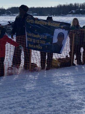 Family holding banners for start of Iditarod race.