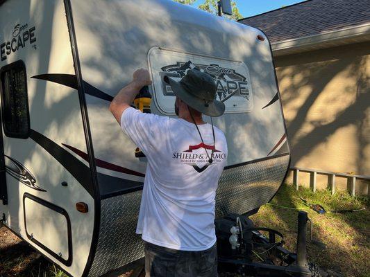 Polishing out the oxidation on the front cap of customers rv.