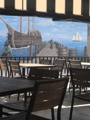 Restaurant across the way with the beautiful pirates On the wall right next to the police station
