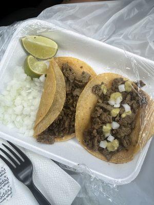 Bistec taco (steak taco). Corn tortillas. Onions. Green salsa.