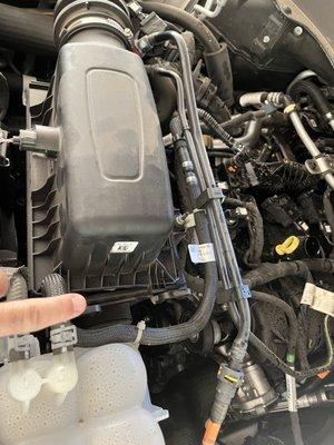 Air filter housing not secured after service.