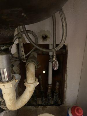 Hole cut under the cabinet in the 2nd bathroom