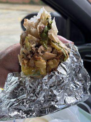 Large, mixed meat wrap with extra sunshine sauce, opened end for better view.