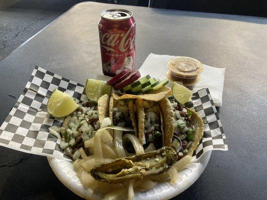 Taco de asada highly recommended w tostada and grilled jalapeño and onions not. Red salsa and lime . Al pastor taco too .