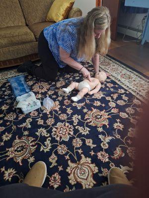 This is hands-on practice. Our student is learning the technique of two finger CPR on an infant