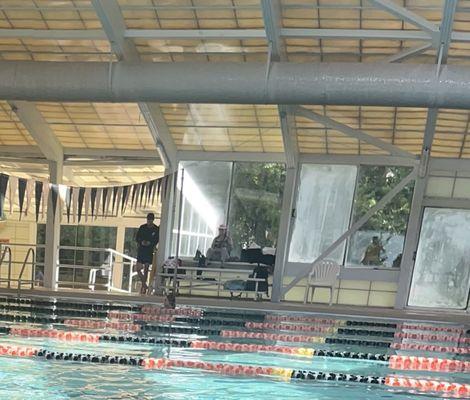 100 degrees without humidity. Only one fan. Glass enclosure. Most windows closed. Hottest Olympic pool ever.