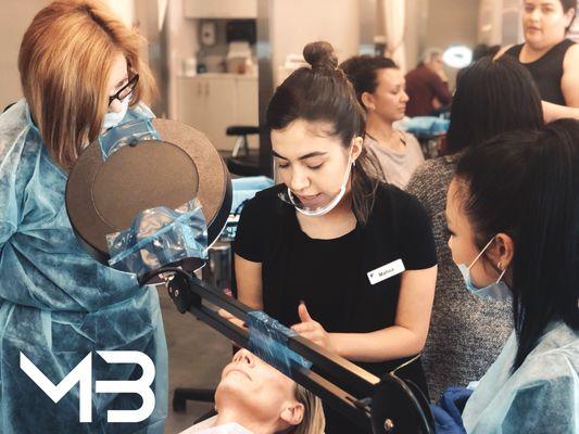 Microblading class work on model with Student's