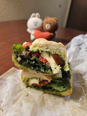 Tuscan Sandwich has arugula, tomato, pesto, red onion, roasted pepper, mozzarella
