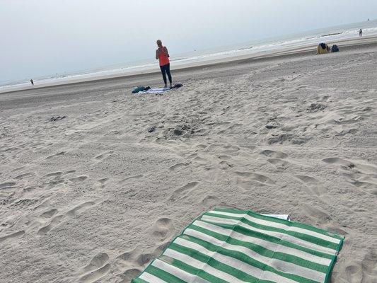 Helene at the end of a yoga on the beach session June 2025
