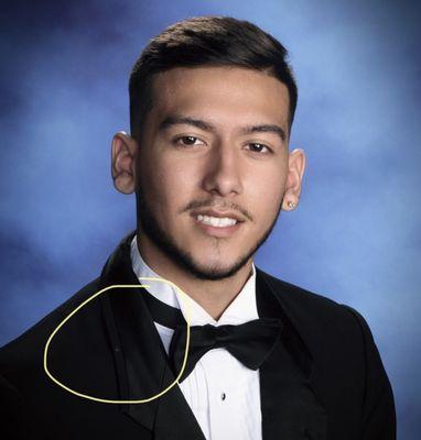 White smudge that was promised it would be edited out but was not. Very tacky looking. This is a coat they provided to all the kids.