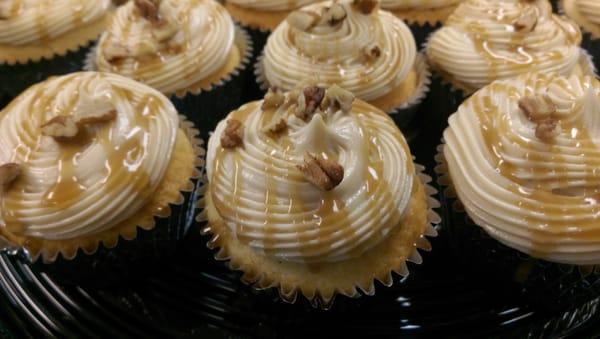 Almond cupcakes with homemade cream cheese frosting pecans and homemade caramel sauce