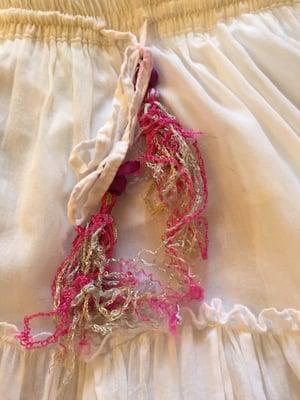 Ruined tassels, colors bled onto white fabric