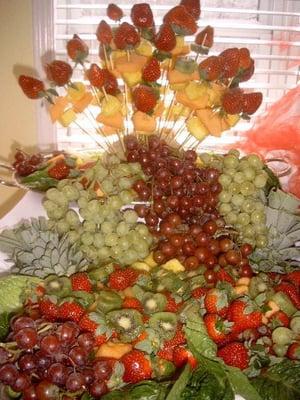 We add special touches to all of our displays, including this fruit display featuring a bouquet of fruit on top of more tiere...
