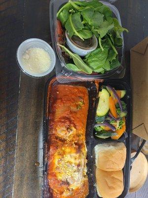 Lasagna. Side salad with 4 tomato slivers and spinach.