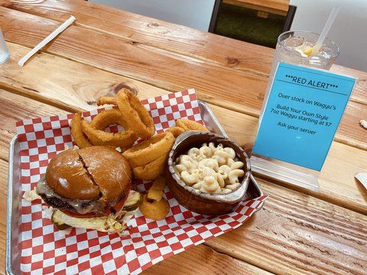 7oz wagyu beef burger with mac & cheese, and onion rings.