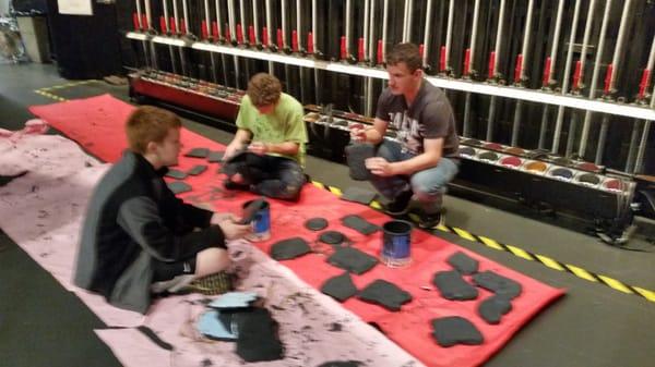 Hard working students creating faux rocks for set construction