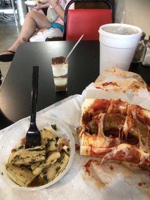 Half a hot italian sausage sub with pesto pasta salad, tea and a sample of tirimisu