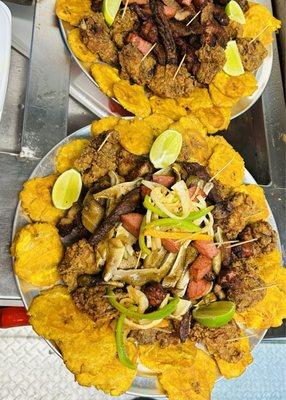 Platter of different meats and freshly prepared food.