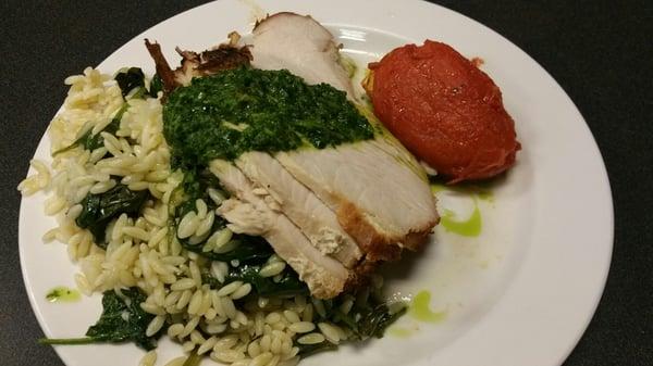 chimichurri topped Roasted Turkey Breast and spinach orzo with a side of roasted romantic tomatoe