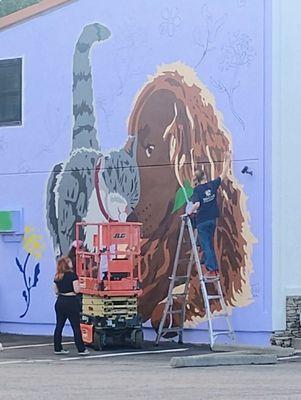 Painting a loving new mural for the animals and owners to enjoy
