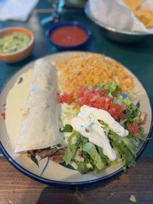 Carne Asada burrito with salad and rice