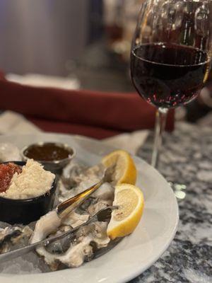 Half dozen oysters and a glass of wine.