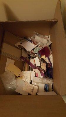 Office supplies just dumped in a box, left half full and then taped shut.