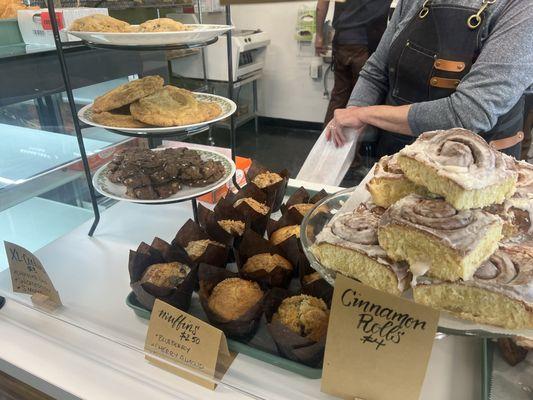 pastry case cinnamon rolls muffins and cookies