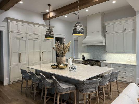 Discretely hidden pantry with Refrigerator/Freezer. Matching wood hood