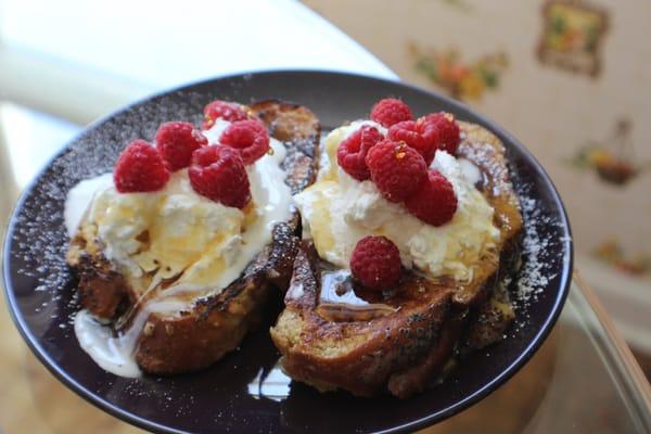 The Decadent! Challah French Toast dipped in ice cream batter, topped with house whipped cream and seasonal berries or fruit.