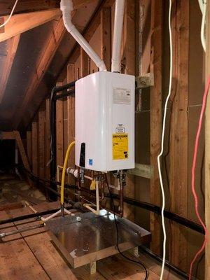 Navien NPE-240A Natural Gas .99 Energy Factor High Efficiency Condensing Tankless Water Heater installed in an upstairs attic