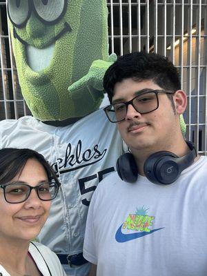 Me and son taking a selfie with Dillon the pickle mascot cut out.