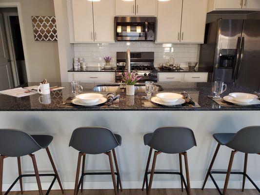 Apartments feature granite islands and countertops in kitchens and bathrooms.