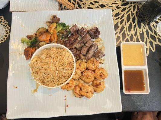 Steak and shrimp combo served with veggies (very flavorful) and rice.