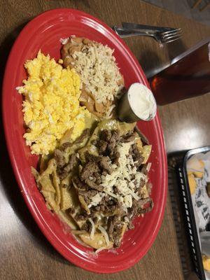 Green chilaquiles with carne asada. The green salsa and chips have a great taste to them.