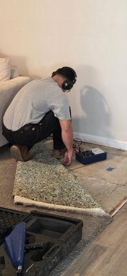 In this photo we are using an amplified listening device (slab leak detection) to detect a water leak underneath the foundation of the home.