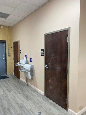 Inside - view of 2 bathrooms at back of the shop