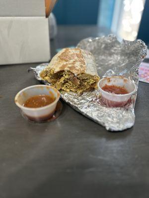 Sausage breakfast burrito with mild and hot salsa.